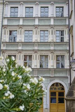 Historic building facade with columns, rows of windows and arched doorway b.. Stock Photos