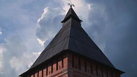 Historic building featuring a tall tower with a cross at its peak. The clouds 動画素材 344527990