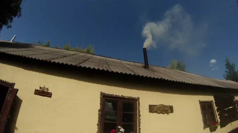 Historic building forge working with smoking chimney under the blue sky Stock Footage 46418270