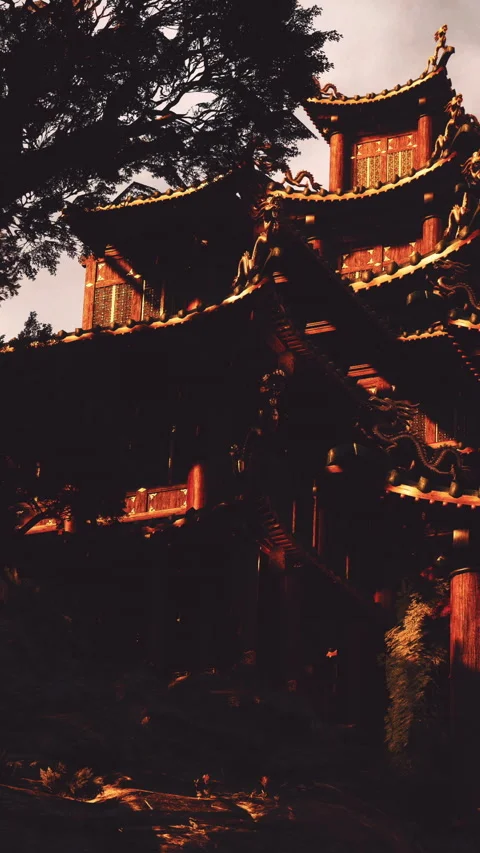 Historic building stands under trees with sun setting in the background Stock Footage 341042034