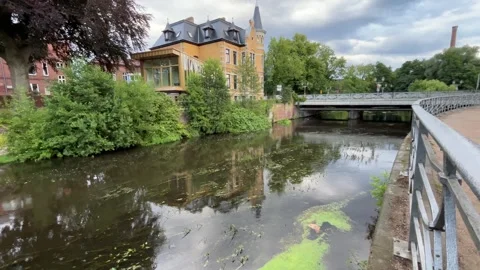 Historic Canal with Bridge and Reflections in European Town Stock Footage 340442875