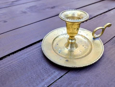 A historic candlestick on the table Stock Photos