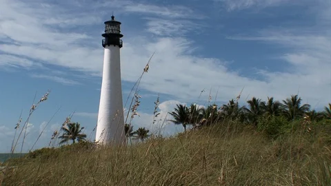 Historic Cape Florida Lighthouse-pan left reveal-sea oats and beach grass Video stock 115089622