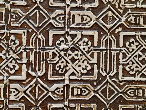 Historic ceramic tile featuring complex arabesque designs amidst weathered .. Stock Photos
