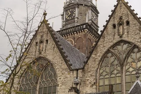 Historic church with gothic elements, tower clock and stone decorations against Foto stock