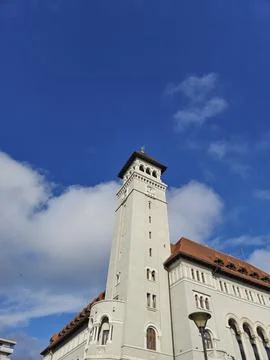 Historic clock tower against blue sky and clouds Stock Photos