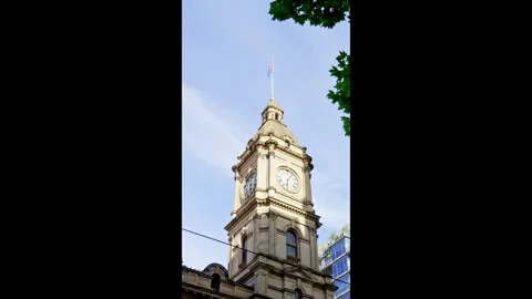 Historic Clock Tower with the Australian flag in Central Melbourne Stock Footage 324692527