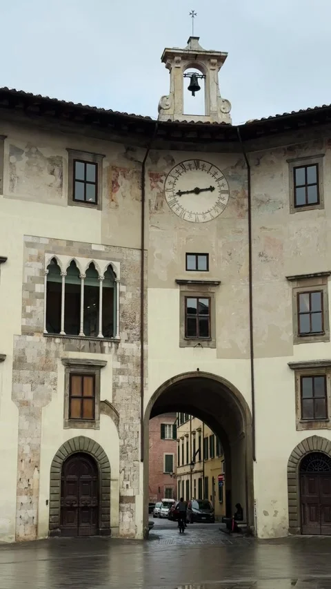 Historic clock tower building with archway in the old town of Pisa Stock Footage 308241533