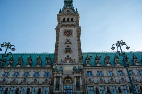 Historic clock tower building under blue sky Stock Photos