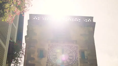 Historic clock tower illuminated by sunlight in understanding town center Stock Footage 327629668