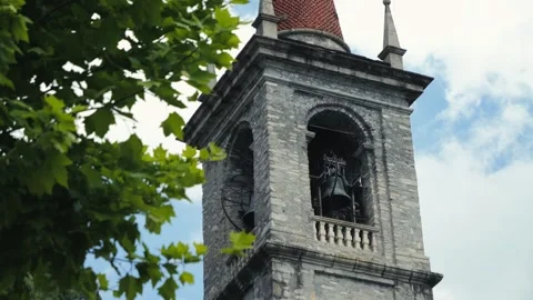 A historic clock tower in Italy, surrounded by trees and blue skies. Stock Footage 327797066