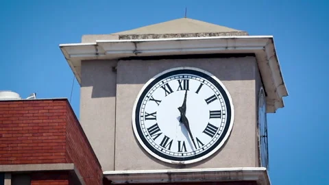 Historic clock tower landmark in city skyline at sunset 스톡 동영상 332450253