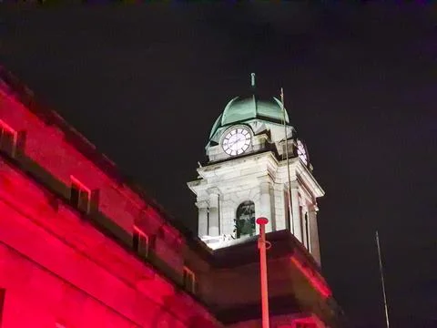 Historic clock tower at night with dramatic lighting Stock Photos