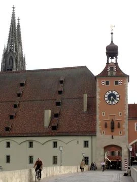 Historic Clock Tower Stands Watch Over the Old Stone Bridge in Regensburg, .. Stock Photos