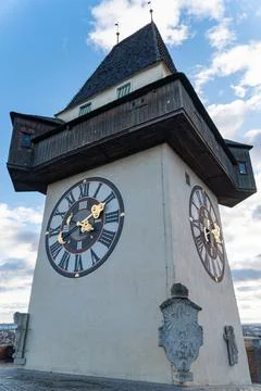 Historic Clock Tower with Twin Clock Faces Against Blue Sky Stock Photos