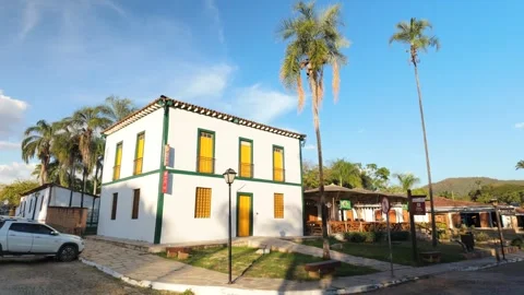 Historic colonial architecture facade with palm trees under blue sky Stock Footage 339256441