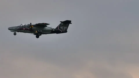 Historic combat jet airplane in flight at low speed with landing gear down Stock Footage 159697217