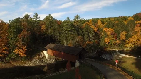 Historic covered bridge drone shot in Autumn with brightly colored leaves Stock Footage 122746964