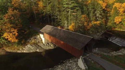 Historic covered bridge drone shot in Autumn with brightly colored leaves Stock Footage 122747586