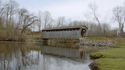 Historic covered bridge over the river in Lowell, Michigan. 4k60p Stock Footage 128850571