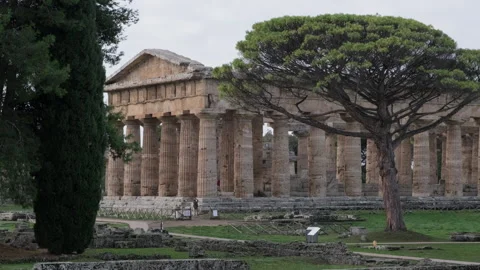 Historic Doric temple of Hera surrounded by moody clouds in Paestum Italy Stock Footage 319775899