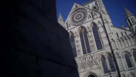 Historic gothic York Minster sliding into shot against a bright blue sky 스톡 동영상 73290539