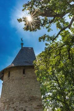 Historic half shell tower on the old city wall in Wernigerode in backlight Stock Photos