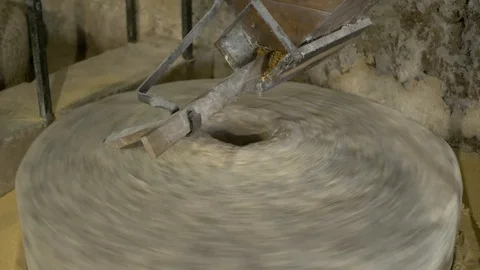 Historic hand-driven millstone grinding wheat - clese-up Stock-Footage 94191342