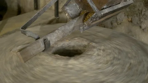 Historic hand-driven millstone grinding wheat - close-up Stock-Footage 94192080