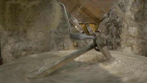Historic hand-driven millstone grinding wheat - extreme close-up (left side) Stock-Footage 94192764