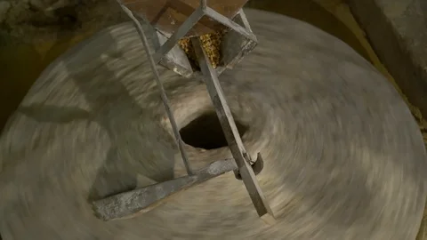 Historic hand-driven millstone grinding wheat - overhead shot Stock-Footage 94194038