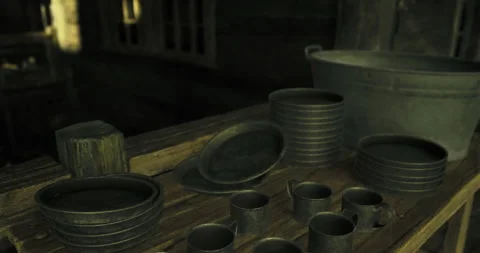Historic kitchenware on display in a rustic setting with dim lighting Stock Footage 327260978