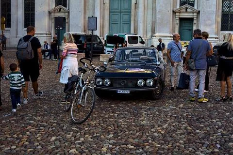 Historic Lancia car surrounded by people on a square during the 2022 Gran Pre Stock Photos