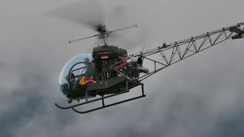 Historic light helicopter in flight in cloudy sky side tracking view Stock Footage 167021318