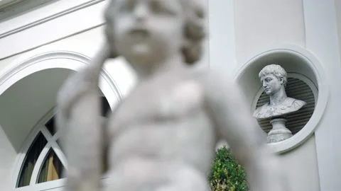 Historic marble statue of child on the background of white villa palace Video stock 158799997