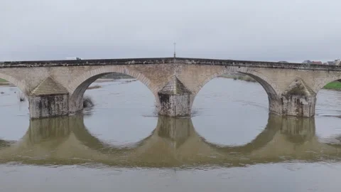 A historic medieval stone bridge spanning a river in Gien, France. The bridge Stock Footage 346712330