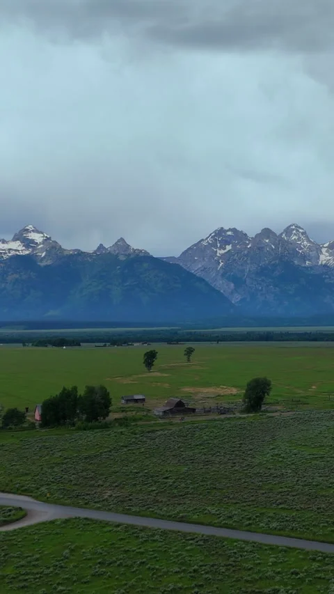 Historic Mormon Row Barn with Grand Teton National Park Mountains in Montana. Stock Footage 342587732