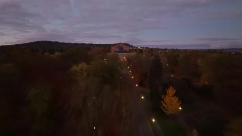 Historic Opera House Revealed by Drone at Dusk Above Wooded Cityscape Stock Footage 343441902