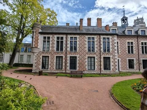 Historic palace building with patterned facade and garden 스톡 사진