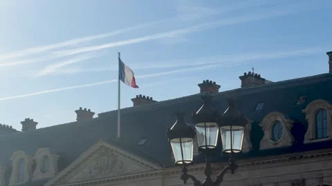 Historic Paris rooftops under blue sky with flags waving gently Stock Footage 337185280