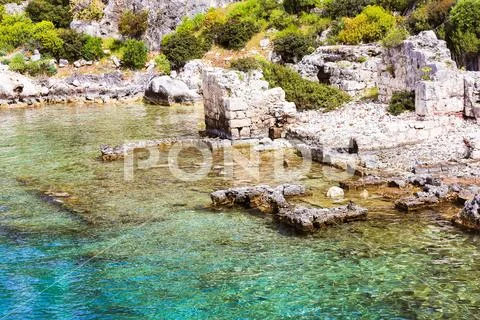 Historic place on the shore of the sea and under clear, clean water Stock Photos