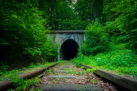 Historic railway tunnel under the mountain. Former German engineering constructi Stock Photos