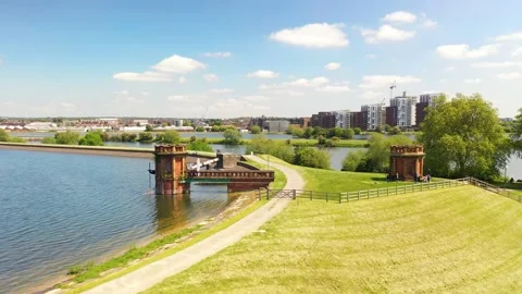 Historic red brick intake tower near dyke of water reservoir from drone Stock-Footage 155782114