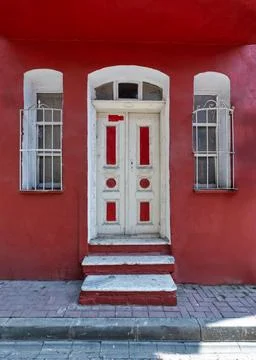 Historic red house facade with white door and windows in Balat, Istanbul, Turkey Stock Photos