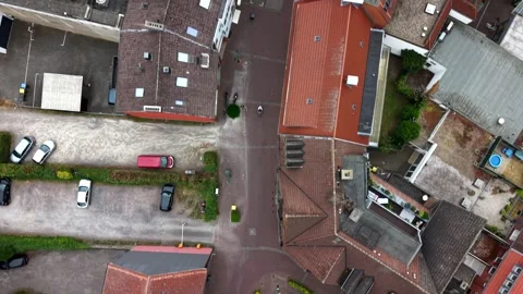 Historic red-tile rooftops cluster around cobblestone crossroads in small Stock Footage 340566099
