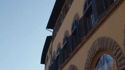 Historic Renaissance Building Facade with Stone Arches and Wooden Shutters .. Stockbeeldmateriaal 340749029