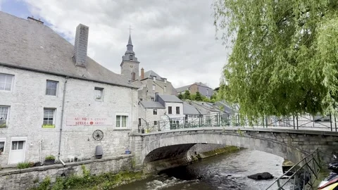 Historic river town with stone arch bridge Stock-Footage 341293408
