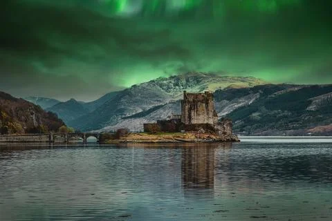 Historic Scottish Castle on Loch Under Northern Lights Stock Photos