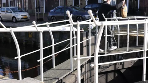 Historic sluice footpath with two walkers over canal Видео 335287987