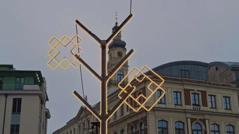 Historic square with luminous decor, Intricate lamp setup over aged facades Stock Footage 325127593